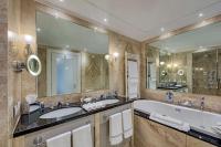 a bathroom with two sinks and a large mirror at Hilton Molino Stucky Venice in Venice