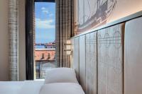 a bedroom with a bed and a window with a view at Hilton Molino Stucky Venice in Venice