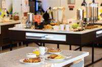 a table with three plates of food on it at Hampton By Hilton Toulouse Airport in Blagnac
