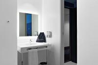 a white bathroom with a sink and a mirror at Hampton By Hilton Toulouse Airport in Blagnac