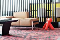 a living room with a couch and a red toy at Hampton By Hilton Toulouse Airport in Blagnac