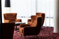 two chairs and a table in a hotel room at Hampton By Hilton Toulouse Airport in Blagnac