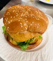 een sandwich op een wit bord op een tafel bij Knotty Pine Cottages, Suites & Motel Rooms in Ingonish Beach