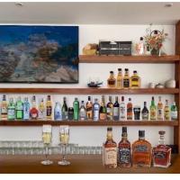 a shelf filled with lots of bottles of alcohol at X-Sea Khanom Harbor Bay Resort in Khanom