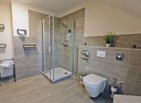 a bathroom with a shower and a toilet at Hotel Zur Sonne in Waren