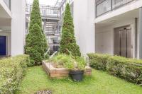 a courtyard with trees and plants in a building at Appart&#39;City Confort Pau Centre in Pau