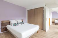 a white bedroom with a large white bed and a closet at Appart&#39;City Confort Pau Centre in Pau