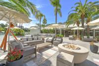 a patio with chairs and a fire pit and umbrellas at Hilton Irvine/Orange County Airport in Irvine