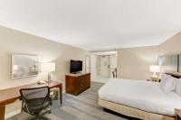 a hotel room with a bed and a desk and a television at Hilton Irvine/Orange County Airport in Irvine