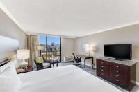 a hotel room with a bed and a flat screen tv at Hilton Irvine/Orange County Airport in Irvine