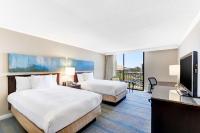 a hotel room with two beds and a flat screen tv at Hilton Irvine/Orange County Airport in Irvine