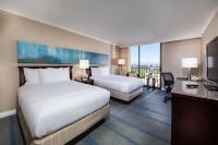 a hotel room with two beds and a television at Hilton Irvine/Orange County Airport in Irvine