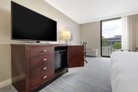 a hotel room with a flat screen tv on a dresser at Hilton Irvine/Orange County Airport in Irvine