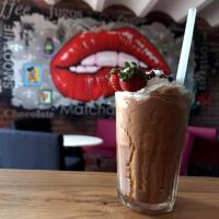 Un batido con una fresa encima sobre una mesa. en Casa Blanca San Miguel, en San Miguel de Allende