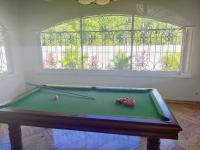 a pool table in a room with a window at Villa Gardenia in Kourou