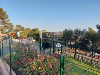 a park with a playground with pink flowers at L&#39;arbre perché in Saint-Raphaël