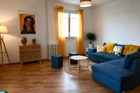 a living room with a blue couch and a table at Grand appartement cosy-Hyper Centre-Place Verdun in Tarbes