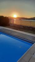 a swimming pool with the sunset in the background at Villa Playa del Sol -B4 in Saint-Tropez
