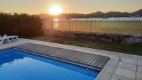 a swimming pool with a sunset in the background at Villa Playa del Sol -B4 in Saint-Tropez