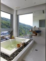 a bathroom with a tub with a large window at Hotel Double One in Taipei