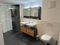 a bathroom with two sinks and a shower and a toilet at Apart Finazzer in Wenns