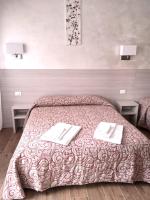 A bed or beds in a room at Hotel Parco Fiera
