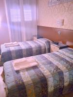 A bed or beds in a room at Hotel Parco Fiera
