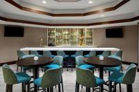 a bar with blue chairs and tables in a restaurant at DoubleTree Suites by Hilton Charlotte/SouthPark in Charlotte