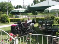a couple of people sitting at a table with a bike at Hotel &amp; Restaurant ,,Zur Alten Oder&quot; in Frankfurt-Oder in Frankfurt Oder