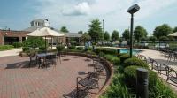 a patio with tables and chairs and a pool at Hilton Garden Inn Macon&#47;Mercer University in Macon