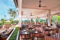 a restaurant with tables and chairs on a patio at Sheraton Samui Resort in Chaweng Noi Beach