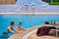 a man and a woman sitting in a swimming pool at Sheraton Samui Resort in Chaweng Noi Beach