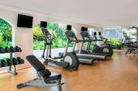 a gym with a row of treadmills and exercise bikes at Sheraton Samui Resort in Chaweng Noi Beach