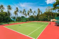 a tennis court with palm trees in the background at Sheraton Samui Resort in Chaweng Noi Beach