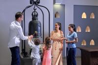 a man shaking the hand of a woman and two children at Sheraton Samui Resort in Chaweng Noi Beach