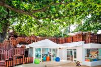 a house with a playground in front of a tree at Sheraton Samui Resort in Chaweng Noi Beach