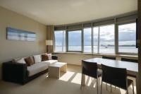 a living room with a couch and a table at Atlantic Hotel Sail City in Bremerhaven