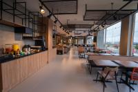 瓜拉普阿瓦ibis Guarapuava的一家有桌椅和窗户的餐厅