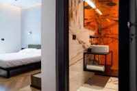 a bedroom with a bed and a bathroom with a sink at Adriatic Luxury Suites in Pescara