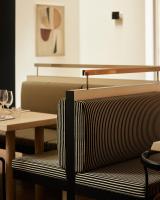 a restaurant with a table and a bench and a table and chairs at Morgan & Mees Rotterdam in Rotterdam