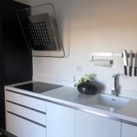 a white kitchen with a sink and a microwave at Penthouse 120 m2 vue imprenable Lattes in Lattes