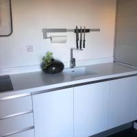 a kitchen counter with a sink and a knife holder at Penthouse 120 m2 vue imprenable Lattes in Lattes