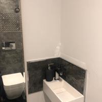 a bathroom with a white toilet and a sink at Penthouse 120 m2 vue imprenable Lattes in Lattes