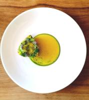 un piatto bianco con un pezzo di broccoli sopra di Farlam Hall Hotel & Restaurant a Brampton