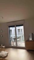 a room with a large sliding glass door with a patio at Chic &amp; moderne appartement - proximité métro in Asnières-sur-Seine