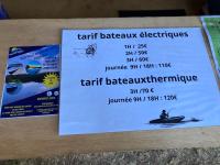 a ticket for a boat ride on a table at F1 noir&#47;anis, avec terrasse couverte et jardin (E) in Compreignac