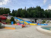 a water park with a water slide and a pool at F1 noir&#47;anis, avec terrasse couverte et jardin (E) in Compreignac