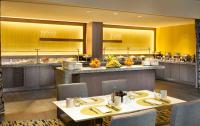 a restaurant with tables and chairs and a buffet at Hilton San Francisco Airport Bayfront - No Resort Fee in Burlingame