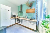 a kitchen with white cabinets and a blue wall at Le Boudoir Vieux Lyon-Fourviere 4 pers in Lyon