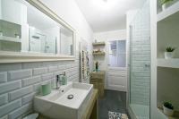 a white bathroom with a sink and a shower at Le Boudoir Vieux Lyon-Fourviere 4 pers in Lyon